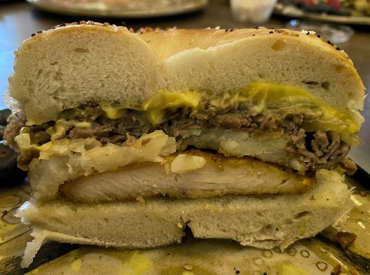 The Court Order: Saucy, thin-sliced grilled roast beef (more than shown!) topping fried chicken, sauteed onions, and fries, yum.