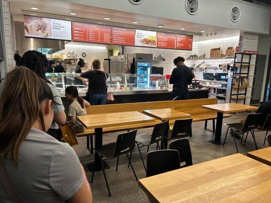 People waiting to be served with no one at the counter