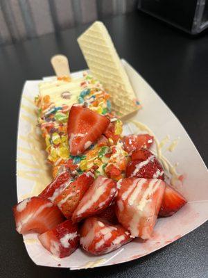 Mine : banana paleta with fruity pebbles and strawberries with white chocolate drizzle .