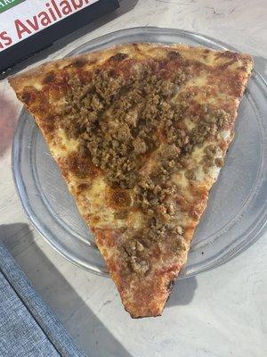 Giant slice of sausage pizza