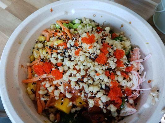 Spicy salmon bowl with a ton of add ins and toppings