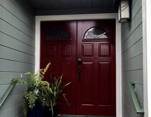 The red front door. Used to be stained wood which was beyond weathered. Painting perfection