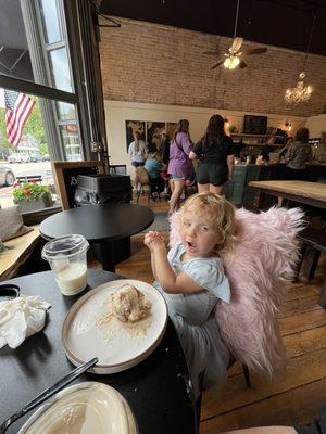 My two year old clearly enjoying the cinnamon roll