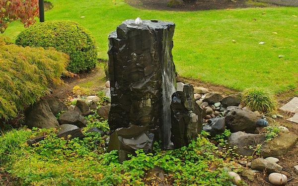 A bubbling rock water feature graces a Winterbloom landscape.