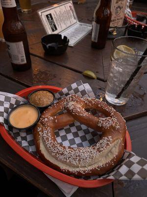 Pretzel with cheese sauce and mustard