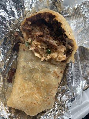 Asada burrito without beans or lettuce. Well seasoned meat, cheese, rice, pico de Gallo, on a buttery griddled tortilla!