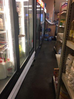 Small aisle to the cold drinks, cheese and other refrigerated stuff