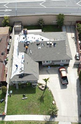 Installing shingles on customers home.