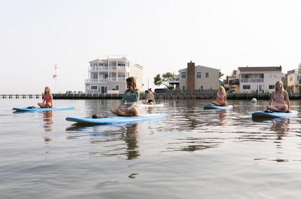 Standup paddle board yoga class on LBI at Bayview Park.