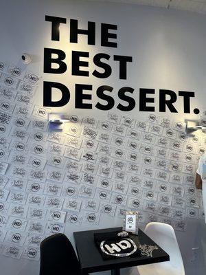 Wall inside restaurant displaying customer messages on custom postcards.