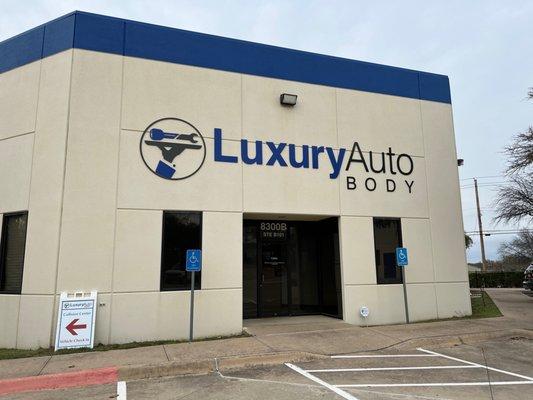 Luxury Auto Body is located behind the main service building on Lamar Blvd.