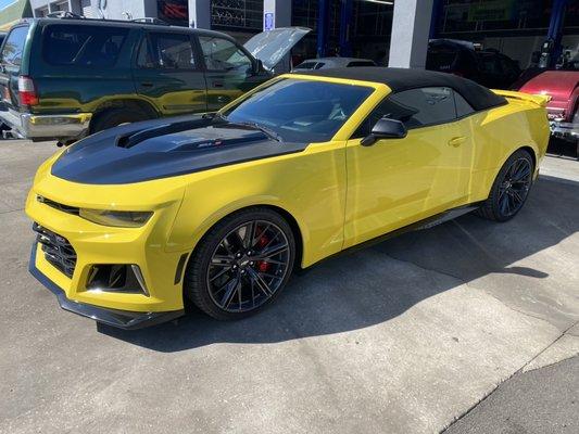 Chevrolet Camaro ZL1 in for brake caliper paint and satin black vinyl hood and mirror wrap.