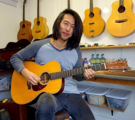 Peter Chung picking up his newly restored Martin. www.neelyguitars.com