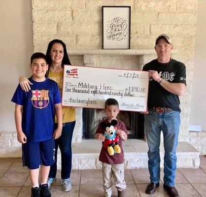 Veteran hero's home benefit check-Little one says, "We got a big check just on tv."