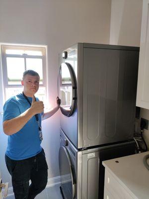 dismantling old household appliances moving to the garage and installing new dryers and washing machines