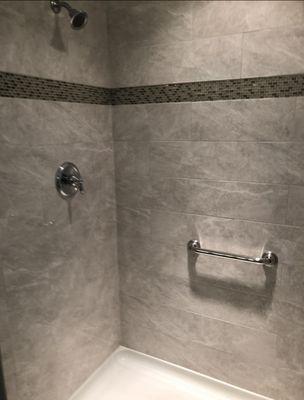 Stall Shower tile installation with mosaic design strip and marble corner shelf. Pepe Tile Installation. Tile installer South Jersey.