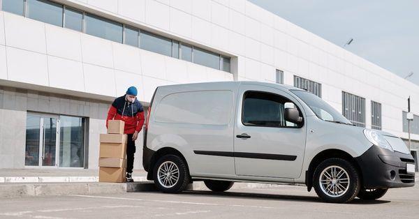 Delivery driver with van loading boxes