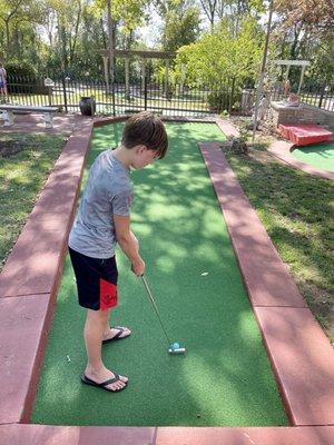 My great nephew about to shoot a hole-in-one