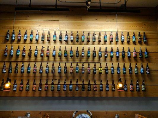 Wall of beer bottles.