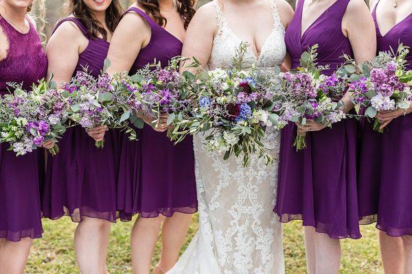 bridal bouquet with 5 bridesmaids bouquets in purples and lavenders.