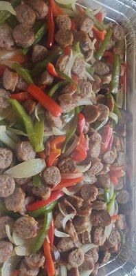 Catering tray of sausage, peppers, and onions.