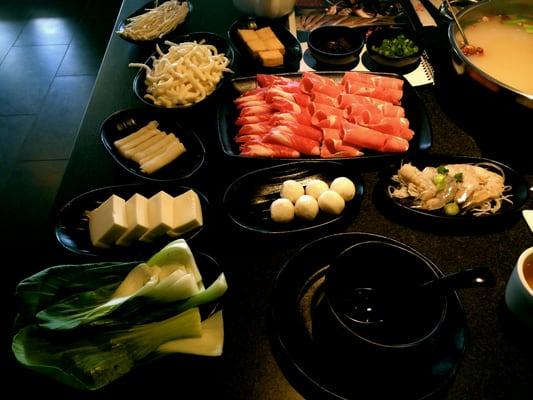 bok choy, tofu, hot pot dumplings, udon noodles, fish balls, and shrimp