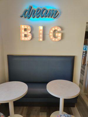 The seating area and a motivational "Dream Big" wall