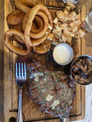 The Ribeye chefs choice steak with onion rings garlic herb butter, red potatoes and sautéed mushrooms! With homemade ranch