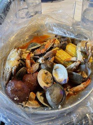 Build your own Clams and blue crab boil in juicy sauce