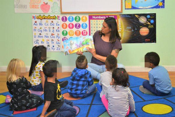 Ms. Jasmine reading to the Busy Bees (3 yr olds)