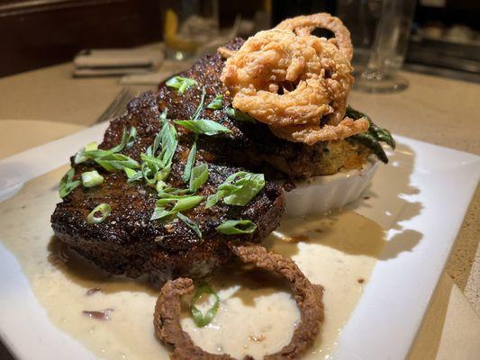 Blackened Ribeye with potatoes au gratin, tobacco onions and grilled asparagus.