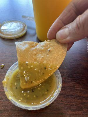 Tortilla chip with absolutely delicious green sauce