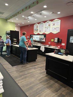 Front counter with menu for ordering and to-go fridge.