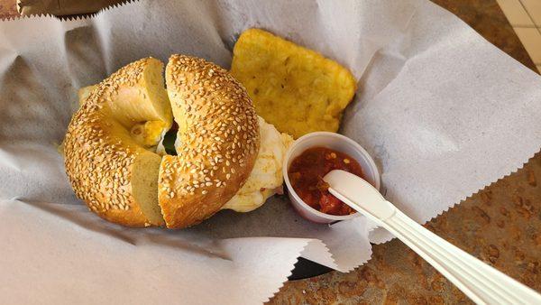 The western on a toasted sesame bagel with salsa and a hash brown.