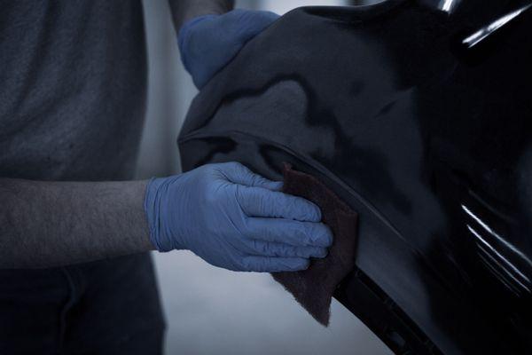 Rick, our paint technician, sanding a bumper cover