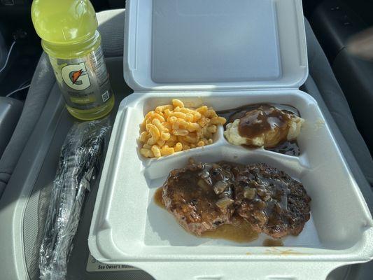 Hamburger steak with macaroni and mashed potatoes.