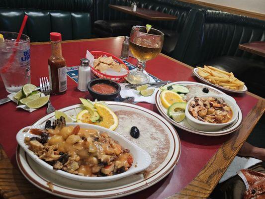 Seafood platter with beans and baked potato.  Shrimp, octopus and chile platter over garlic sauce with beans and fried