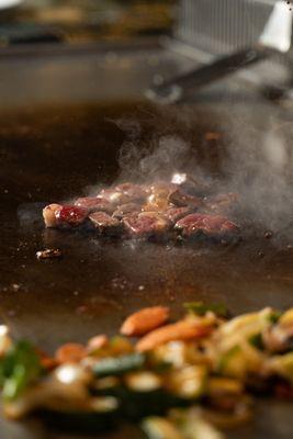 Steak Sizzling on Hot Hibachi Grill