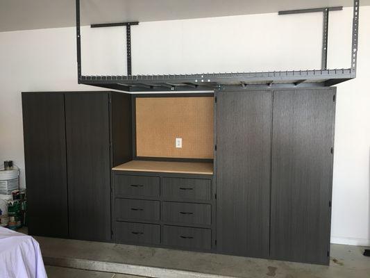 Cabinets, workbench and an overhead rack. Plenty of storage