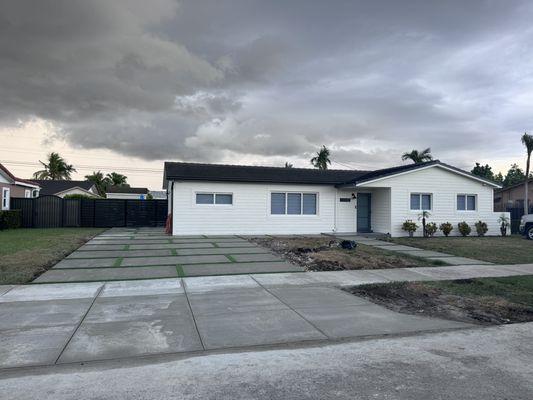 Driveway with walkway and artificial turf inserts.