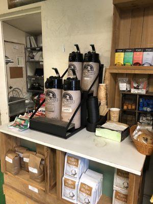 Coffee service and donuts (left side of coffee)