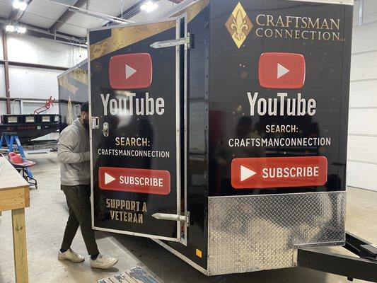 Zilla employee finishing up the trailer wrap of Craftsman Connection trailer right on schedule or ahead of the promised time.