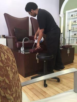 No running water. The technician pouring water retrieved from a connecting apartment building for foot scrubs.