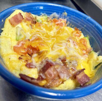 Breakfast bowl: eggs, bacon, tomatoes, avocado, cheese