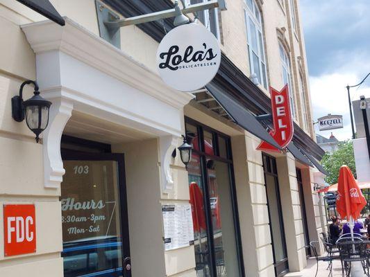 Cute outside entrance with a few tables to dine on during nice weather.