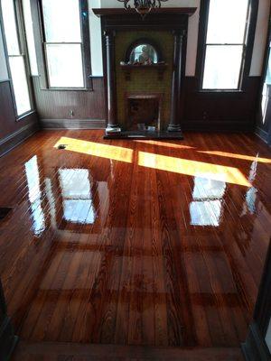 Longleaf pine flooring in the process of being finished. A Fresh coat of poly will dull out after it cures.