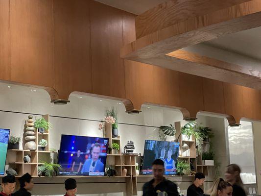 Sushi bar in dining area has 3 TVs