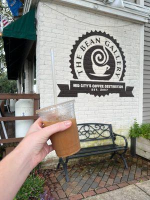 Cold brew w/oat milk outside of the shop