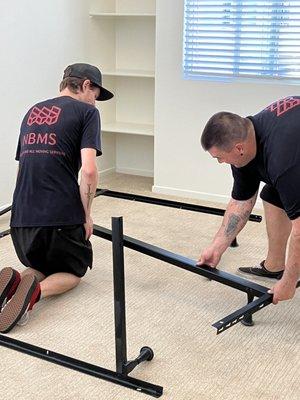 Kyle and Derek assembling a bed frame