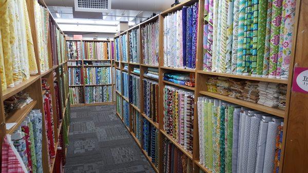 Rows of quilting fabric 90% priced at $6.95 a yard everyday. Mesa has 10,000 bolts Batiks to Kona Solids, Cuddle, Grunge, Fairy Frost, +